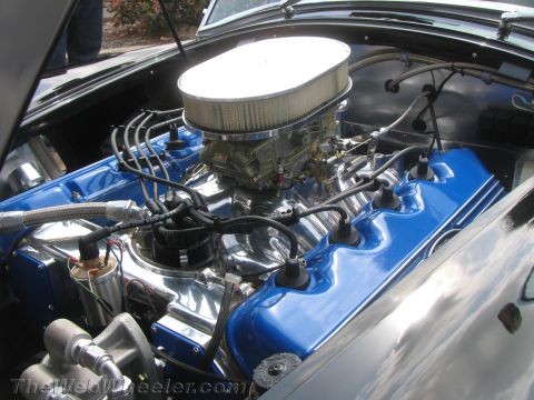 1968 Ford Mustang - Close-up view of a custom engine bay bright blue valve covers and a prominent chrome air cleaner assembly.