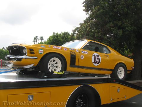 1968 Ford Mustang - A yellow 1969 Ford Mustang Boss 302 race car is loaded onto a yellow tow truck.