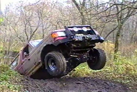 1988 Ford Bronco - This vehicle is navigating a challenging off-road course, demonstrating its capabilities on rough terrain.