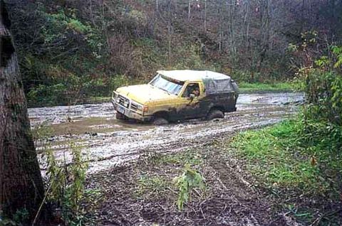 1988 Ford Bronco - This 1988 Ford Bronco is deep in the mud on a trail.