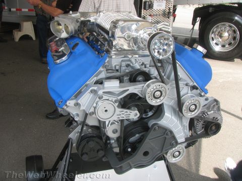1968 Ford Mustang - A highly detailed engine assembly a prominent supercharger and bright blue valve covers is displayed.