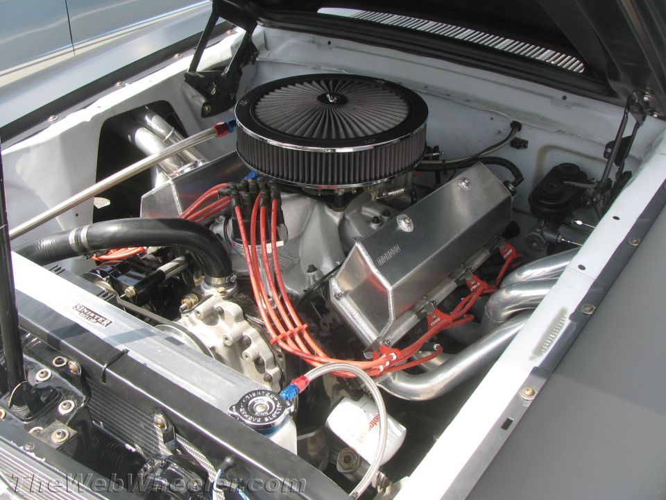 Engine bay with a V8 engine, air filter, and custom exhaust