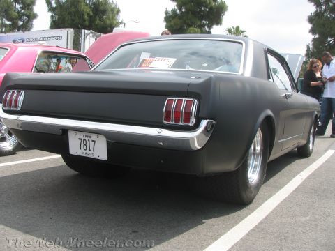1968 Ford Mustang - Rear view of a black 1965 Ford Mustang coupe parked at an outdoor event.