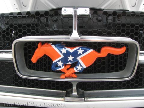 1968 Ford Mustang - Close-up of a running horse emblem on a vehicle's grille, decorated with a Confederate flag design.