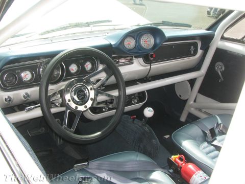 1968 Ford Mustang - The interior of a classic car features a roll cage and racing seats, suggesting a modified build.
