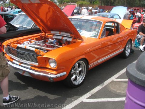 1968 Ford Mustang - Customized 1965 Ford Mustang GT350 displayed at a car show with its hood up.