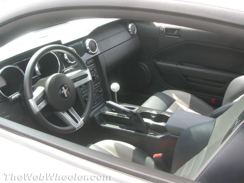 Interior view of a Ford Mustang with a manual shifter and two-tone seats