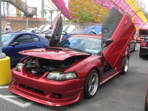 1968 Ford Mustang - A red Ford Mustang with custom doors and hood open is displayed at an outdoor event.