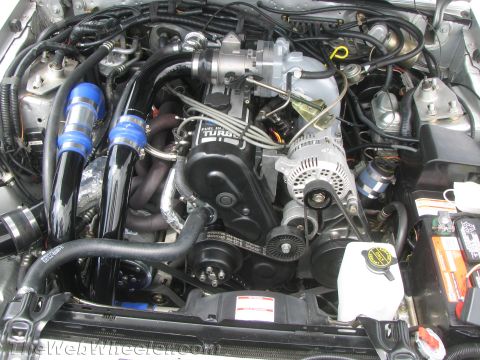 1968 Ford Mustang - Close-up view of a modified engine bay a turbocharger and custom intake plumbing.