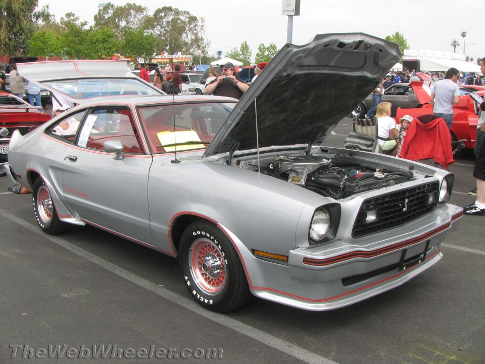 Silver 1975-1978 Ford Mustang II with red trim and hood open