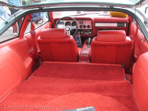 1968 Ford Mustang - The interior of a 1979 Ford Mustang II features red seats, carpeting, and dashboard details.