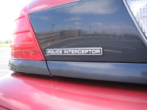 2001 Ford Crown Victoria - A "POLICE INTERCEPTOR" badge is visible on the rear of a car, indicating a police package.