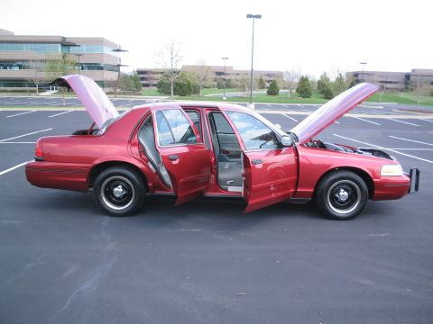 2001 Ford Crown Victoria - This red 2001 Ford Crown Victoria has its hood and all four doors open, revealing the interior and engine bay.