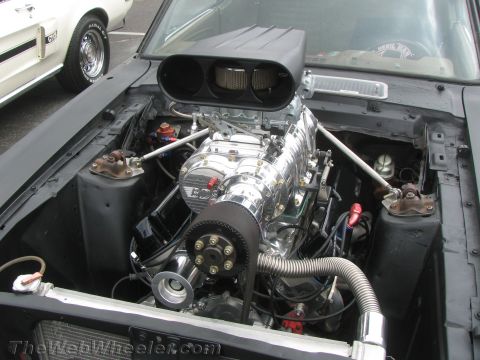 1968 Ford Mustang - Engine bay of a 1968 Ford Mustang a prominent chrome supercharger and dual air intakes.