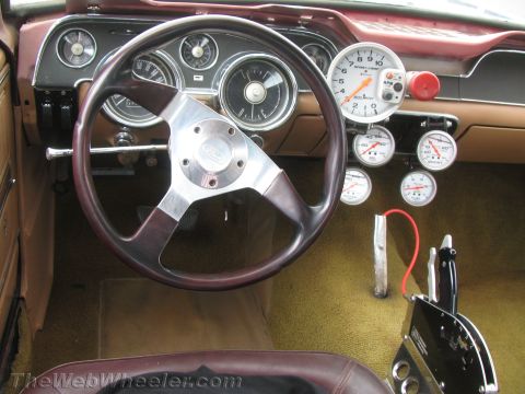 1968 Ford Mustang - Custom 1968 Ford Mustang interior features a tachometer and auxiliary gauges above a Hurst shifter.