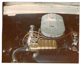 1963 Ford Galaxie - Close-up of an engine bay a large air cleaner and gold-colored valve covers. The Supermotors.net logo is present in the lower right corner.