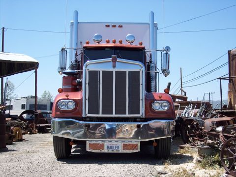 1981 Kenworth W900A - Front view of a 1981 Kenworth W900A semi-truck with a red cab and chrome bumper.