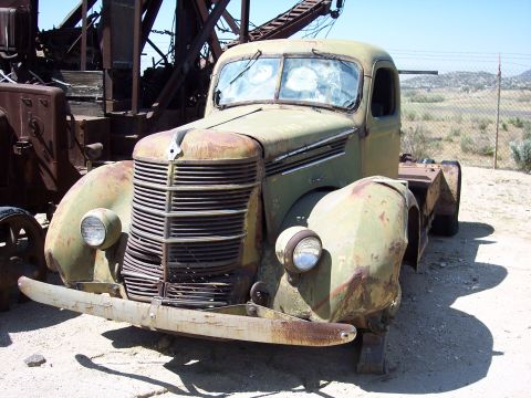 1981 Kenworth W900A - This weathered truck sits abandoned, a relic of a bygone era, with a damaged grille and broken windows.