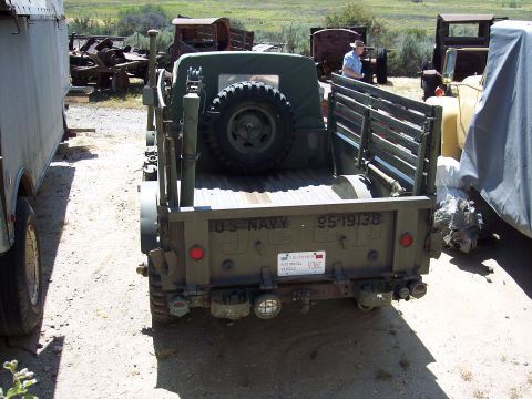 1981 Kenworth W900A - This US Navy Jeep, marked with serial number 95-19138, is seen in a yard with other weathered vehicles.