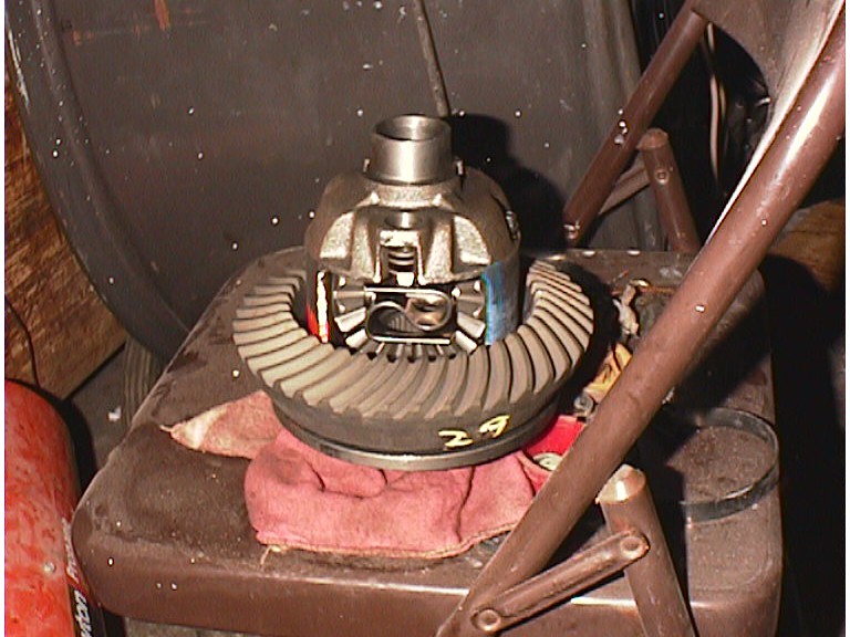 Differential carrier with ring gear clamped on a stand, chalk-marked 29