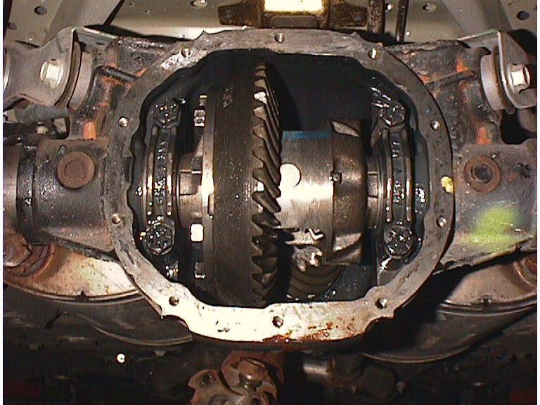 Rear differential with cover removed showing ring gear and carrier inside axle housing