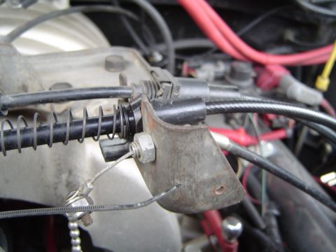 1989 Ford Bronco - Throttle cable and bracket assembly, likely from a vehicle's engine compartment.