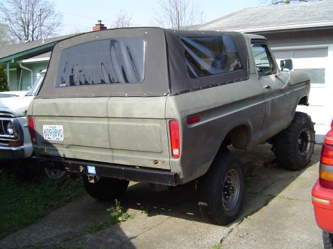 1978 Ford Bronco - A lifted 1978 Ford Bronco is parked in a driveway next to another vehicle.
