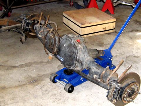 1996 Ford Bronco - A Ford rear axle assembly is shown on a creeper jack in a garage setting.