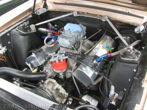 1968 Ford Mustang - The engine bay features a V8 engine with a Holley carburetor and custom valve covers, along with various performance modifications.
