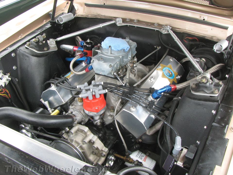 Engine bay with V8 engine, Holley carburetor, and custom valve covers