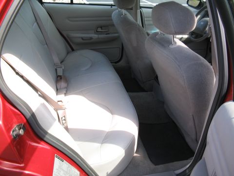 2001 Ford Crown Victoria - Interior view of a red 2001 Ford Crown Victoria, highlighting the light gray cloth seating and door panels.