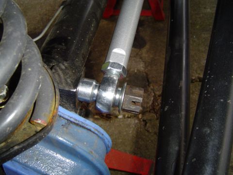 1978 Ford Bronco - Suspension linkage assembly a heim joint and castle nut, with a coil spring visible.