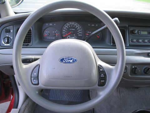 2001 Ford Crown Victoria - Interior view of a 2001 Ford Crown Victoria, highlighting the dashboard and steering wheel.
