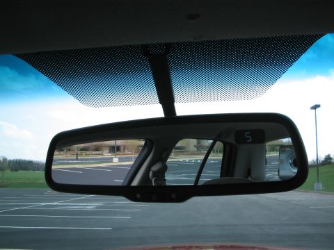 2001 Ford Crown Victoria - View through the rearview mirror shows a parking lot and a digital display reading '5'.
