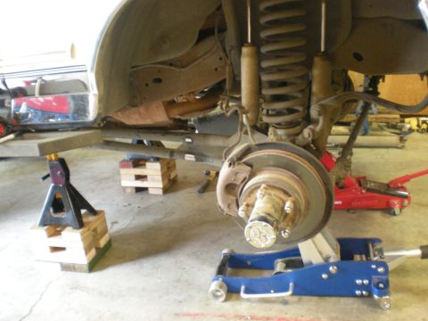 1993 Ford Bronco - The front suspension of a 1993 Ford Bronco is shown with coil springs, shock absorbers, and disc brakes, indicating it is undergoing mainte…