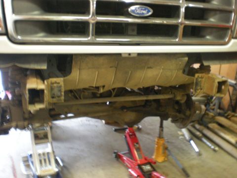 1993 Ford Bronco - Front suspension and grille of a 1993 Ford Bronco, lifted for service.