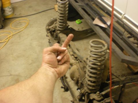 1993 Ford Bronco - Close-up view of a vehicle's front suspension and axle assembly, prominent coil springs.