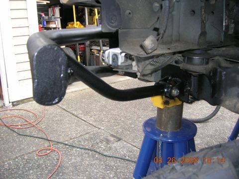 1996 Ford Bronco - Close-up view of a black metal bumper component, supported by jack stands, with a date stamp visible.
