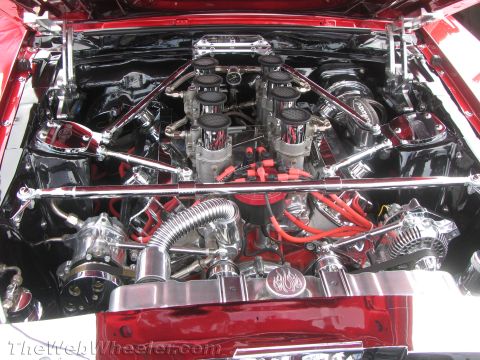 1968 Ford Mustang - The engine bay features a highly customized setup with multiple carburetors and extensive chrome detailing.
