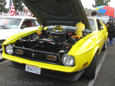 1968 Ford Mustang - Yellow 1971 Ford Mustang at a car show, hood open, decorated with Tweety Bird plush toys.