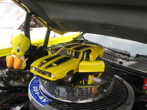 1968 Ford Mustang - A toy car and a plush toy are displayed in the engine bay of a car.