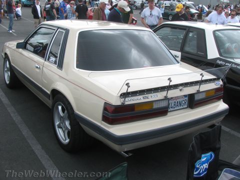 1968 Ford Mustang - This tan Ford Mustang features a prominent rear spoiler and a custom California license plate.