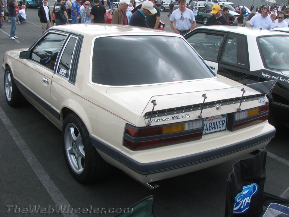 Tan 1987 Ford Mustang rear view with spoiler and custom plate K4BANGR