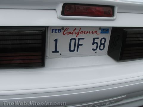 1968 Ford Mustang - The rear of a white vehicle displays a California license plate and dark taillights.