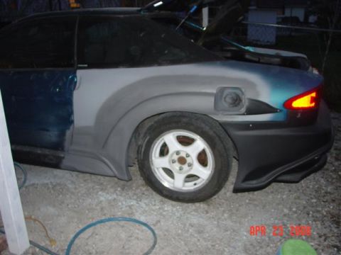 1993 Ford Probe - The rear of a car is shown with bodywork in progress, and another vehicle is visible in the background.
