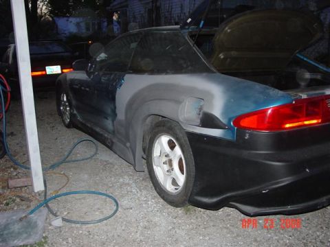 1993 Ford Probe - A 1993 Ford Probe is seen with bodywork in progress, showing primer and unfinished paint on its rear.