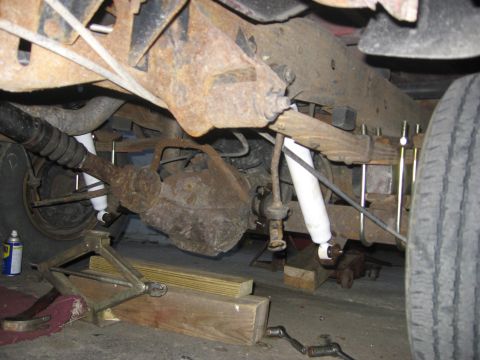 1995 Ford Bronco - Rear suspension components and undercarriage detail, with tools present for maintenance.
