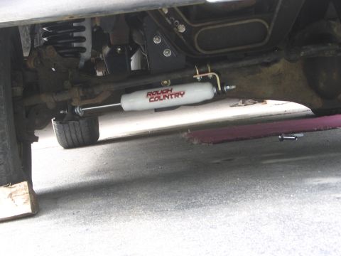 1995 Ford Bronco - Undercarriage shot showing a Rough Country steering stabilizer.
