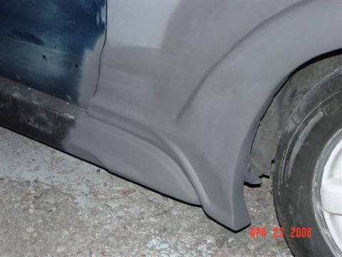 1993 Ford Probe - Car bodywork in progress, focusing on the fender flare and rocker panel area.
