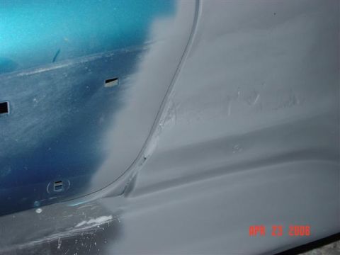 1993 Ford Probe - Bodywork in progress on a vehicle, showing primer and blue paint sections.